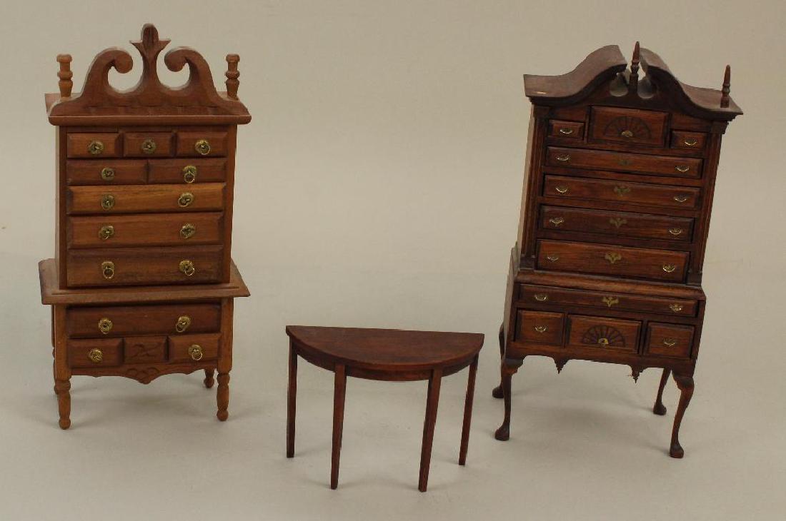 (3) PIECES OF UNPAINTED WOODEN DOLLHOUSE FURNITURE.: Victorian style highboy marked Germany. Queen Anne style highboy, unmarked (finial missing). Side table. Condition: as stated.