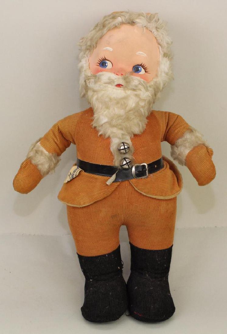 16 1/2" TAGGED 1950's GUND MUSICAL SANTA.: Mask face, faux beard and trim. Still in working order, plays "Jingle Bells". Condition: age discoloration.