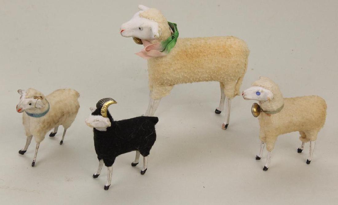 LOT OF (4) PAPIER MACHE SHEEP.: All have painted eyes and are covered with fabric coats. 3" - 5". Condition: loss on ram. This lot is being sold AS IS.