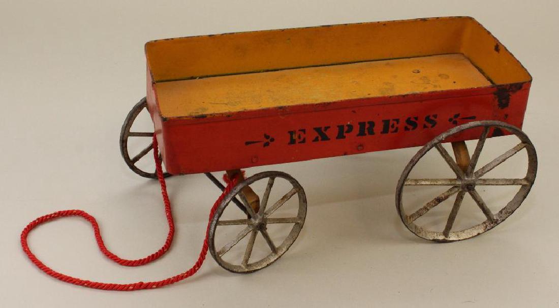 9 1/4" PAINTED PRESSED STEEL, WOOD & CAST IRON "EXPRESS: Red steel sides, orange wood base, silver cast wheels. "Express" has been stenciled on both sides. Condition: paint loss, small areas of rust.