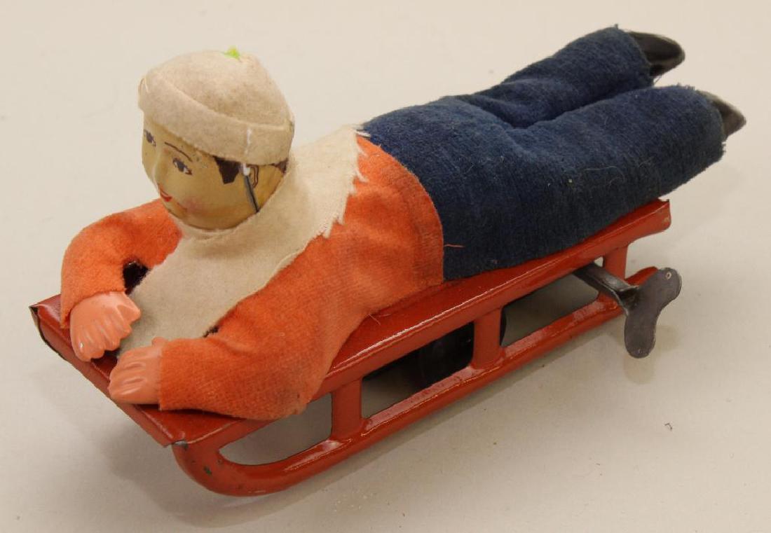 6 1/2"  "BOY ON SLED" TIN WINDUP TOY. (1 of 4)