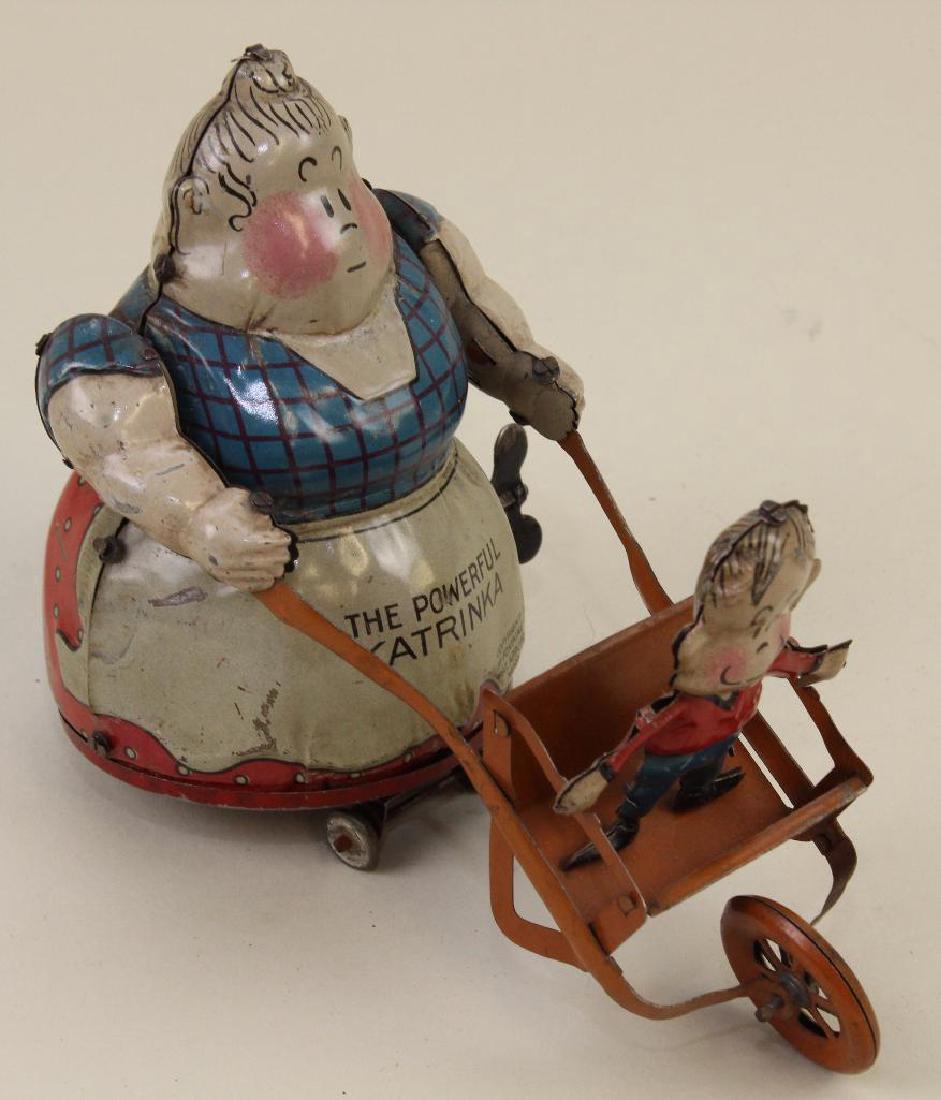 5 1/2" NIFTY "THE POWERFUL KATRINKA" TIN WINDUP TOY. (1 of 4)