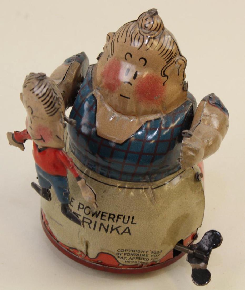 5 1/2" NIFTY "THE POWERFUL KATRINKA" TIN WINDUP TOY. (1 of 4)