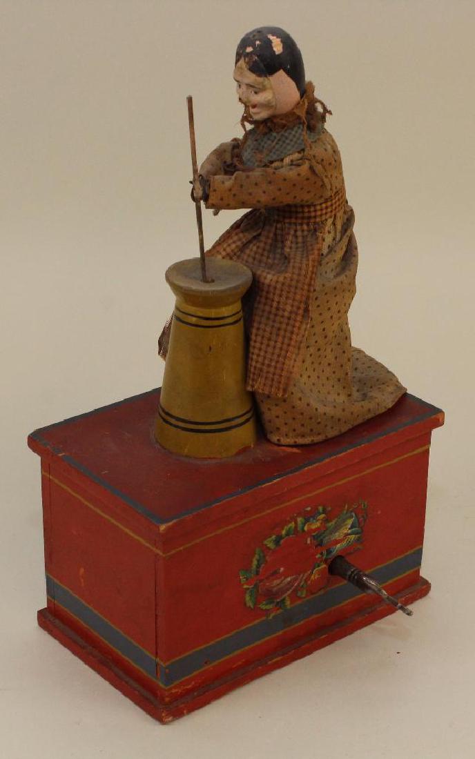 10" IVES WOMAN CHURNING BUTTER ON PLATFORM TOY. (1 of 6)