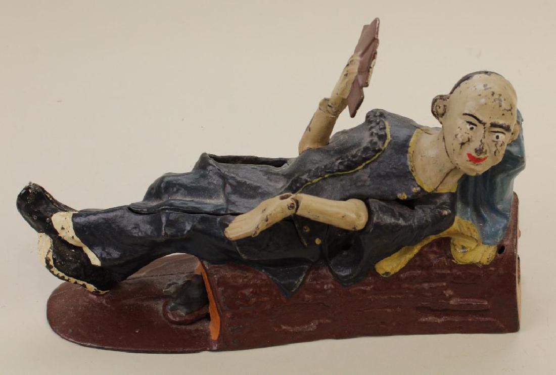 ANTIQUE CAST IRON BANK: "CHINESE RECLINING". (1 of 4)