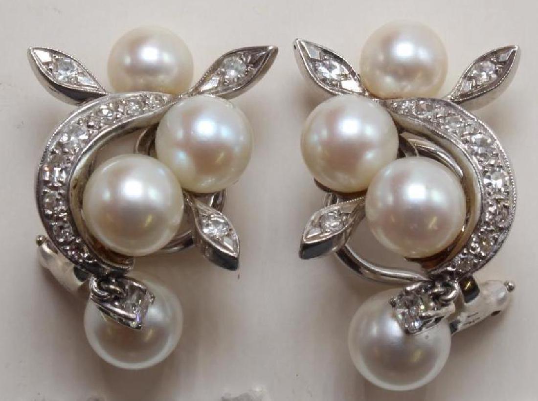 14K White Gold Earrings with Pearl and Diamond: Each omega back post earring features (4) Round Pearls, 6.2mm-7.5mm, (11) graduated round accent Diamonds and (1) 2.9mm round Diamond set stationary above Pearl in dangle. Pair: Approx. .72ctw. 11.7gt