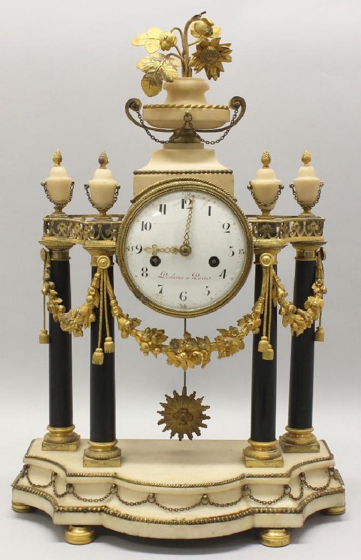 Piolaine White Marble and Ormolu Mantel Clock.: White alabaster, black marble with ormolu frieze. Enameled clock face marked "Piolaine a Paria". Repair and lose to the crowning floral finial. Overall 20"h x 13.5"w x 6.75"d