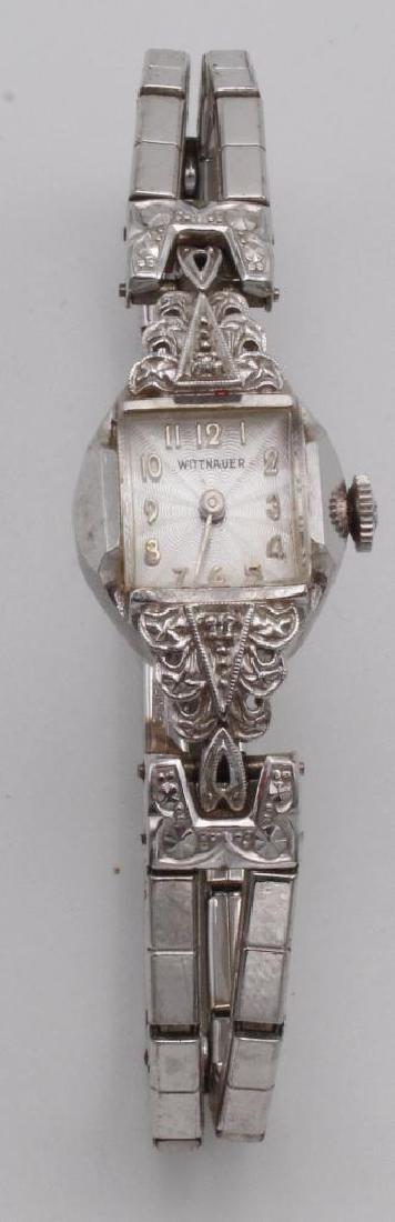 LADIES LONGINES WITTNAUER WATCH. 14K GOLD CASE. DIAMOND: 14KW. 10.9MM SQUARE DOMED CRYSTAL. DECORATIVE DIAL WITH ARABIC NUMERALS. CASE FEATURES (2) SMALL ACCENT DIAMONDS. GEMEX STRETCH BAND. COMES WITH BOX.
