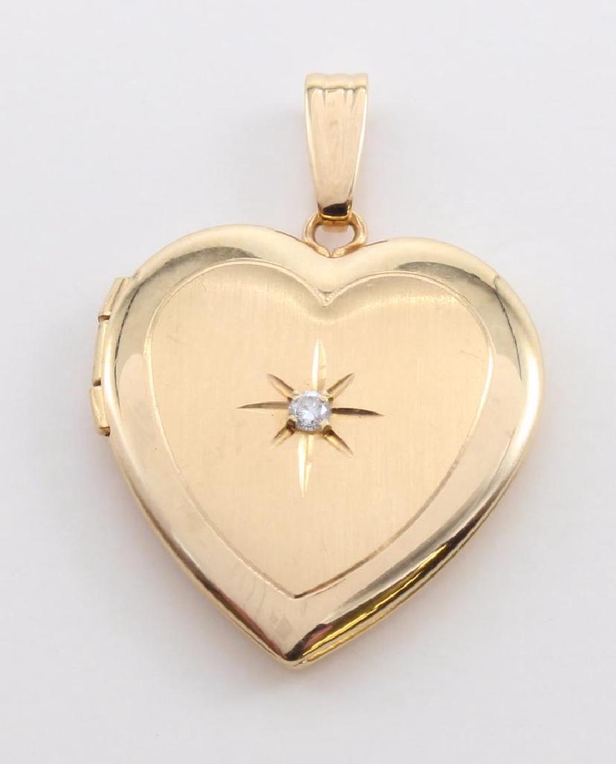 PENDANT. 14K YELLOW GOLD HEART LOCKET WITH DIAMOND: 3/4" HEART. FEATURES (1) .02CT DIAMOND ACCENT. 2.9GTW. 