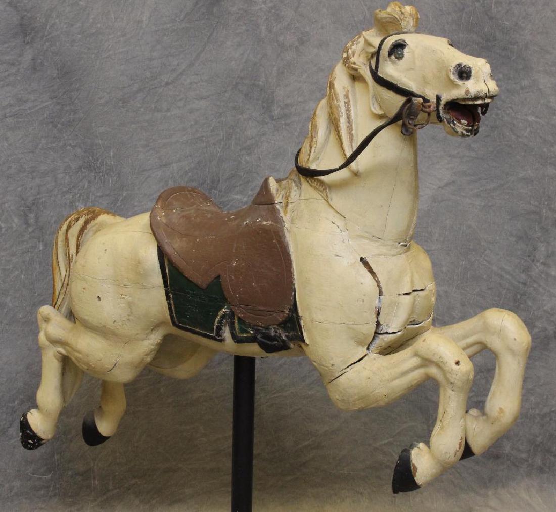 Carousel Jumper Horse: Cream, green, and brown painted on a wooden pedestal base, 60"h x 45"w x 11"d. Crack lines throughout the piece.