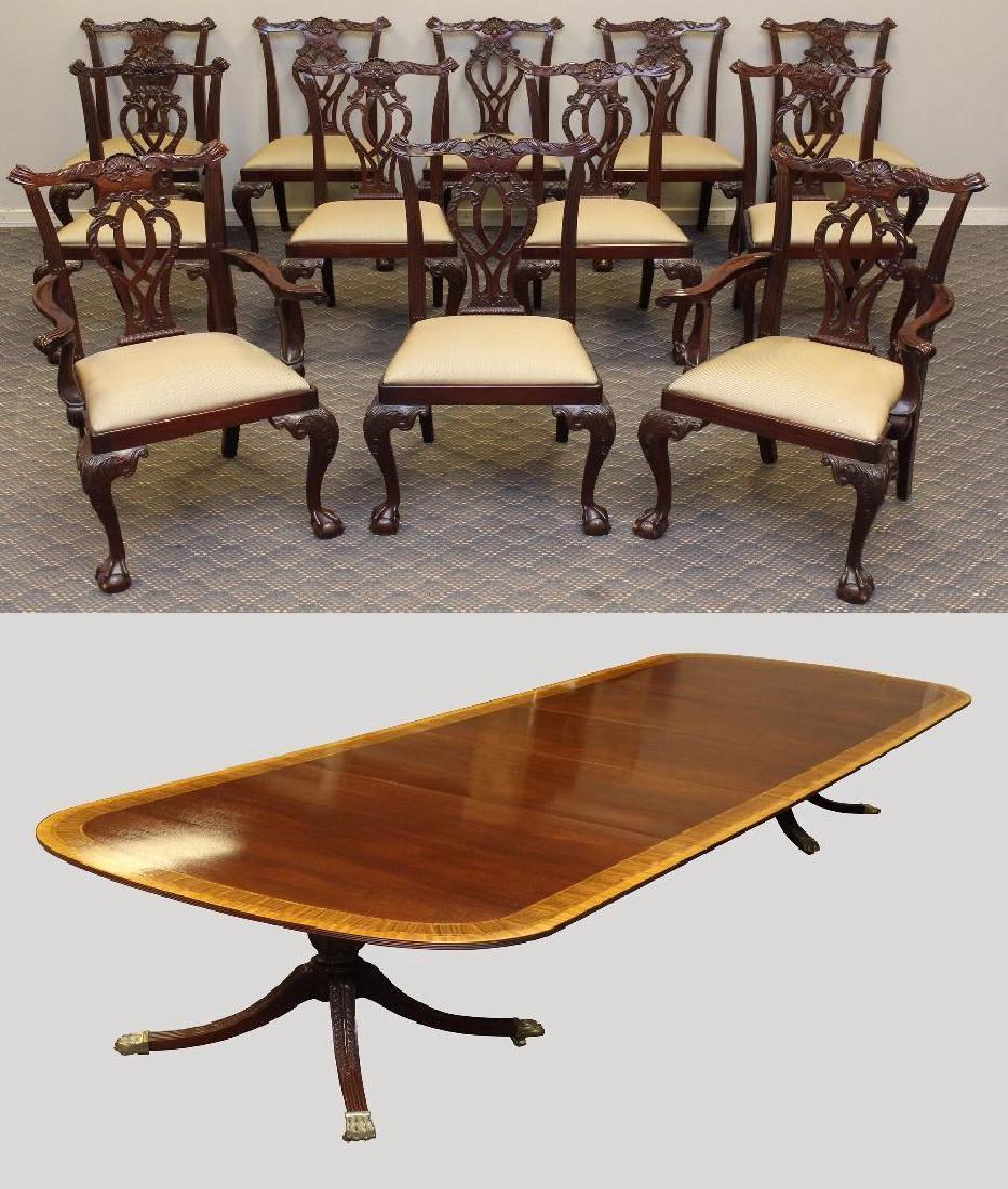 (13) Piece Councill Craftsman Dining Suite: (1) Mahogany banded inlaid extension dining table with two rice carved pedestals with swept feet on brass paw caps and casters, 30"h x 72"w x 47"d with three 20"leaves. (12) Dining chairs with shell c