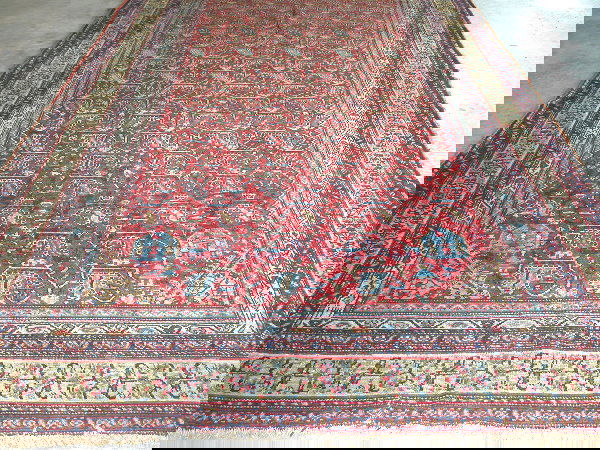 Hamadan.: Central rust panel with overall blue and beige floral decoration, one end with panels featuring figural motifs including female and animal figures, beige and blue borders, dated, 6'8" x 12'4". Conditi