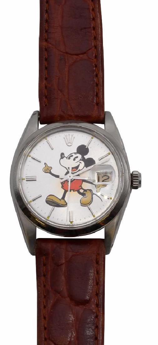 Rolex Mickey Mouse Wrist Watch. 6694: 34mm. Stainless Steel. 17 Jewel manual wind movement. Magnified date window. Leather band with Rolex clasp. Comes with box. 