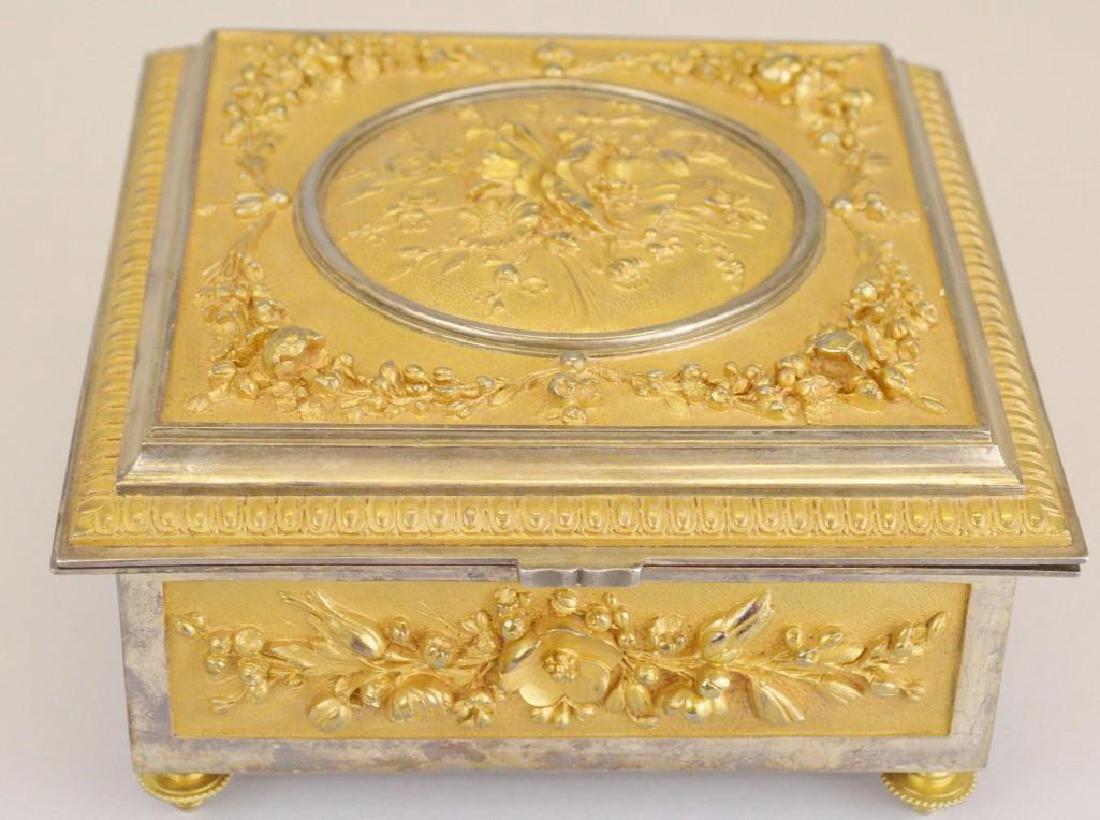 Victorian Ormolu Jewelry Casket: Finely decorated with gilt decoration on silvered metal with floral accents, on raised gilt decorated feet. 4"h x 7"w x 7"d