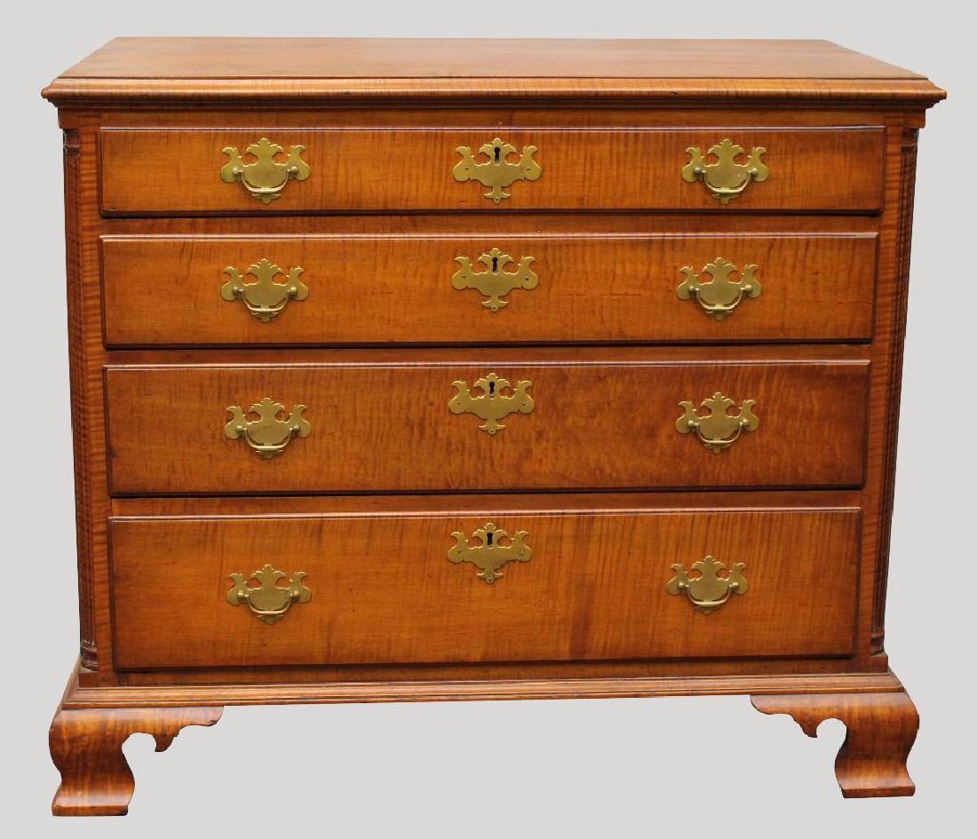 Chippendale Tiger Maple Chest of Drawers: Molded top, reeded columns with four graduated drawers on ogee bracket feet. 34.5" h x 39.5" w x 21.5" d.