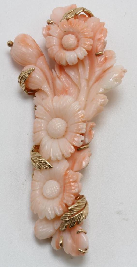 BROOCH PIN. CARVED CORAL. 14K YELLOW GOLD: 3 X 2 1/2" CARVED CORAL DAISY MOTIF IN CUSTOM DESIGNED OPEN BACK SETTING WITH GOLD LEAF PRONGS AND LOCKING C-CLASP. 23.5GTW.