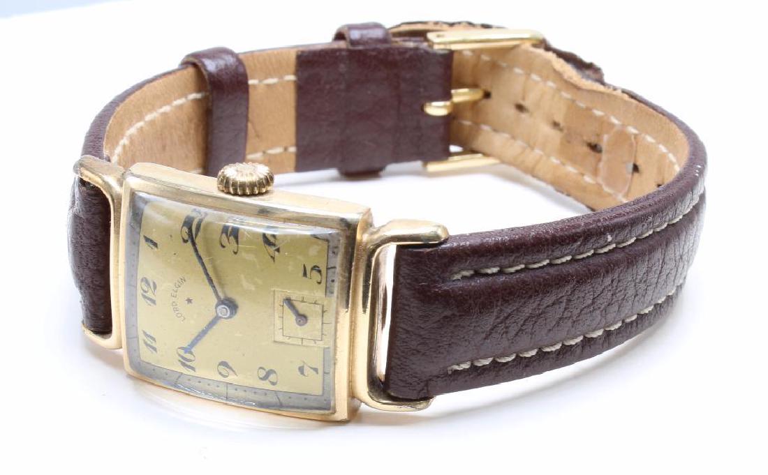 WRIST WATCH. LORD ELGIN. 14K YELLOW GOLD FILLED: 38.5MM LUG END TO LUG END. 17 JEWELS. 673. SERIAL #F821987. SECOND REGISTER. BROWN GENUINE LEATHER 16 R BAND. 