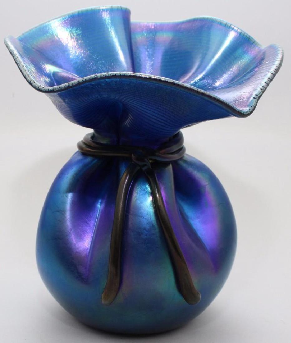 Orient & Flume Art Glass Vase: Blue iridescent tied bag form, signed " Orient & Flume Smallhouse" with serial number and original Orient & Flume sticker. 8.5"h x 7"round