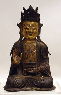 Chinese Gilt Bronze Figure of Quanyin: Seated in dhyanasana, wearing a loosely draped robe and elaborate headpiece, with serene facial expression. Gilt to flesh areas. Old restoration to back and right knee, small crack to headpiece,