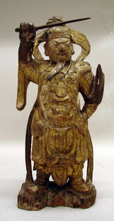 Chinese Carved Wood Guardian of Late Ming Dynasty: 17th C., finely carved standing figure with sword drawn above his head in guardian pose and wearing ornate armor with beast masks at chest and abdomen. Nice remains of gilt, polychrome, and gesso. 