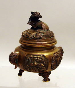 Chinese Gilt Bronze Covered Incense Burner: 17th/18th C., the base well cast with high relief birds in foliate panels, and beast handles. The lid with fine pierce work and large Buddhistic lion finial. Fine hand-chased details. Some old