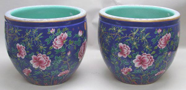 Pair Large Chinese Export Porcelain Famille Rose: 20th C., each a large round fishbowl form tapering to the base, beautifully painted in bright famille rose colors on a blue ground, depicting finely detailed flowers and foliage. Turquoise interior