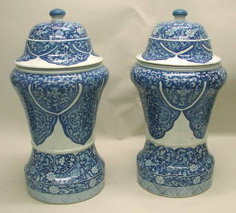 Pair Chinese Porcelain Blue and White Covered Vas: Urn form with fine lappet foliate decoration. 24 ½"h x 13 ½"w.