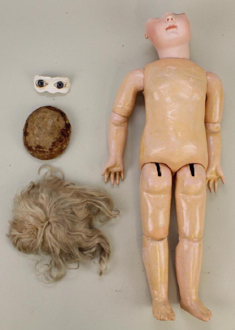 BODY PARTS - 17" TAGGED PAPIER MACHE STEINER BODY, WIG,: Paper label reads: Le Petite Parisien BeBe J. Steiner MEDAILLE D'OR PARIS 1889. Portion of original head. Blonde mohair iwg. "4" Cardboard pate. Pair of blue paper weight eyes. Condition: some repaint