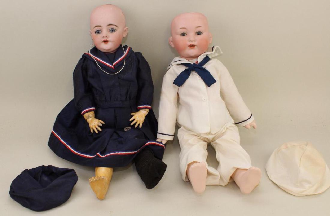 BODY PARTS - PAIR OF ANTIQUE BISQUE HEAD DOLLS.: Both dolls have blue sleep eyes, open mouths, papier mache jointed bodies. No wigs. Both are dressed in newer sailor outfits. 22" S&H 1039 DEP. Pierced ears. Ball jointed body. Condition: head is 