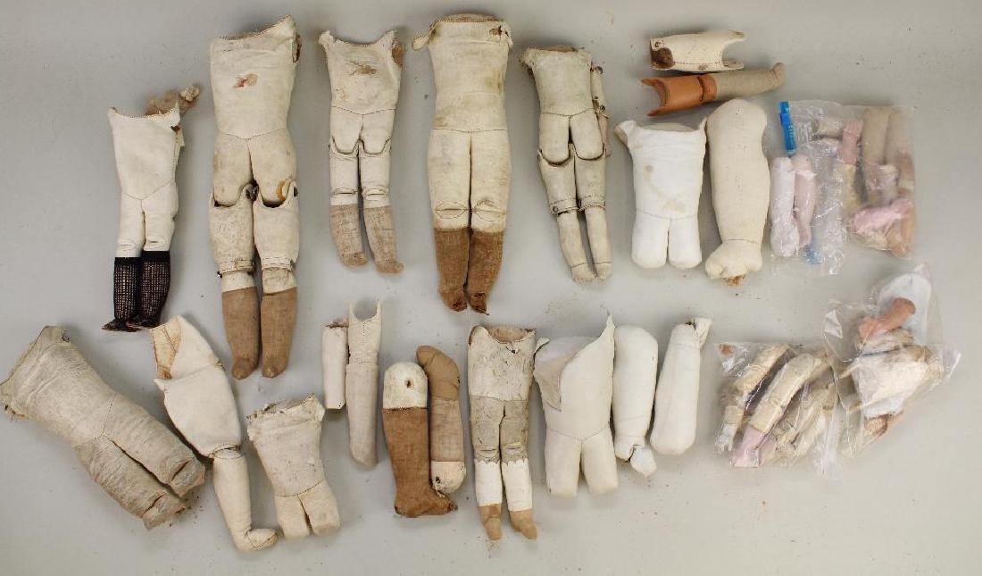 BODY PARTS - LARGE LOT OF ANTIQUE LEATHER BODIES,: Many complete bodies without arms. Several bodies without lower legs and arms. Lot of legs. Lot of lower bisque, papier mache and celluloid lower arms. Condition: this lot is being sold AS IS.