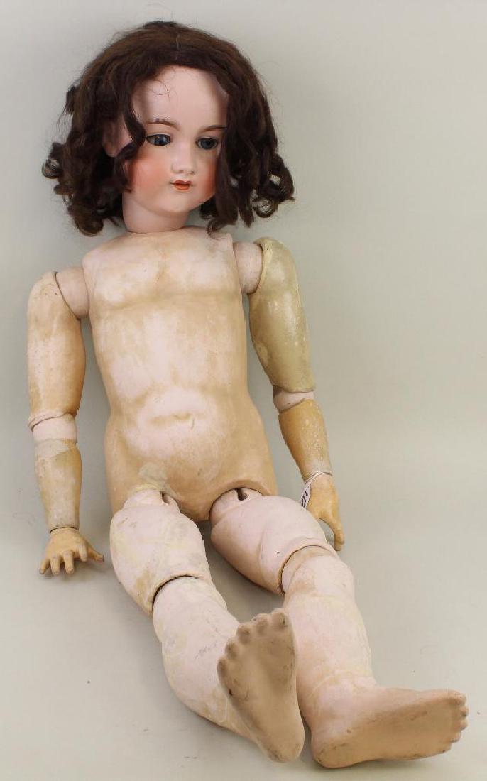 ANTIQUE BISQUE HEAD DOLL - 38" ARMAND MARSEILLE MADE IN: Blue sleep eyes, open mouth, dark brown human hair wig. Papier mache ball jointed body. No clothing. Condition: kiln crack on rim edge. Firing/kiln crack over left ear from ear to rim edge. Hairline u