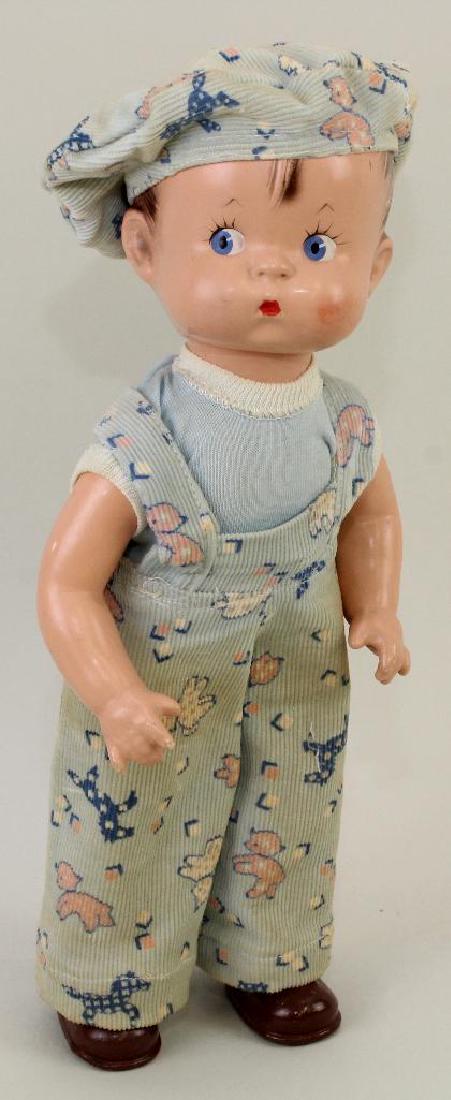 14" 1929 EFFANBEE "SKIPPY" DOLL.: Painted blue side glance eyes, brown hair. Cloth body. Composition head, arms, lower legs with molded shoes/socks. Replaced vintage clothing. Stand. Condition: cheek rub. Light crazing.
