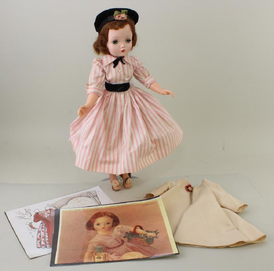21" 1955-1959 ALL ORIGINAL MADAME ALEXANDER "CISSY": Blue sleep eyes, auburn hair. Hard plastic body with vinyl bent elbow arms. Dressed in tagged outfit, shoes. Also, handmade faille coat. Condition: minor age discoloration on clothing. Both eyes are m