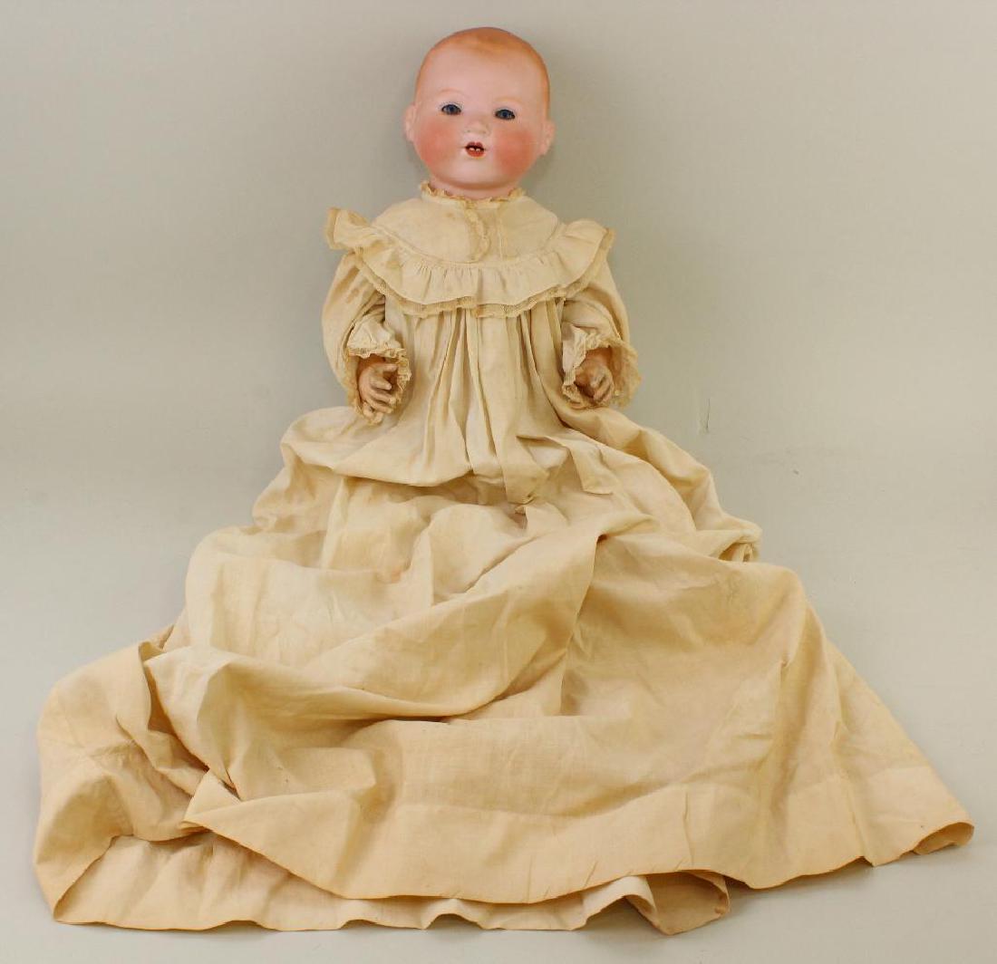 22" L. 16" CIRC. A.M. GERMANY 351/8./K. ANTIQUE SOLID: Blue sleep eyes, open mouth, painted blonde hair. 5 Pc. papier mache bent limb baby body. Dressed in antique child's christening gown. Condition: chip over right eye. Finger missing on left hand. Age 