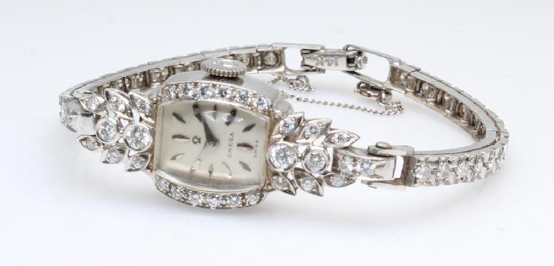 Ladies Omega Wrist Watch. Diamond. Platinum and 14K: 900 Platinum 100 Iridium case (monogrammed M.E.S and dated 12-25-55). 14KW bracelet with safety chain. 6 1/2" long. 17 Jewels. Omega 212 Serial #13430457. Features (32) 2.2mm, (2) 3.0mm, (2) 2.5mm, 