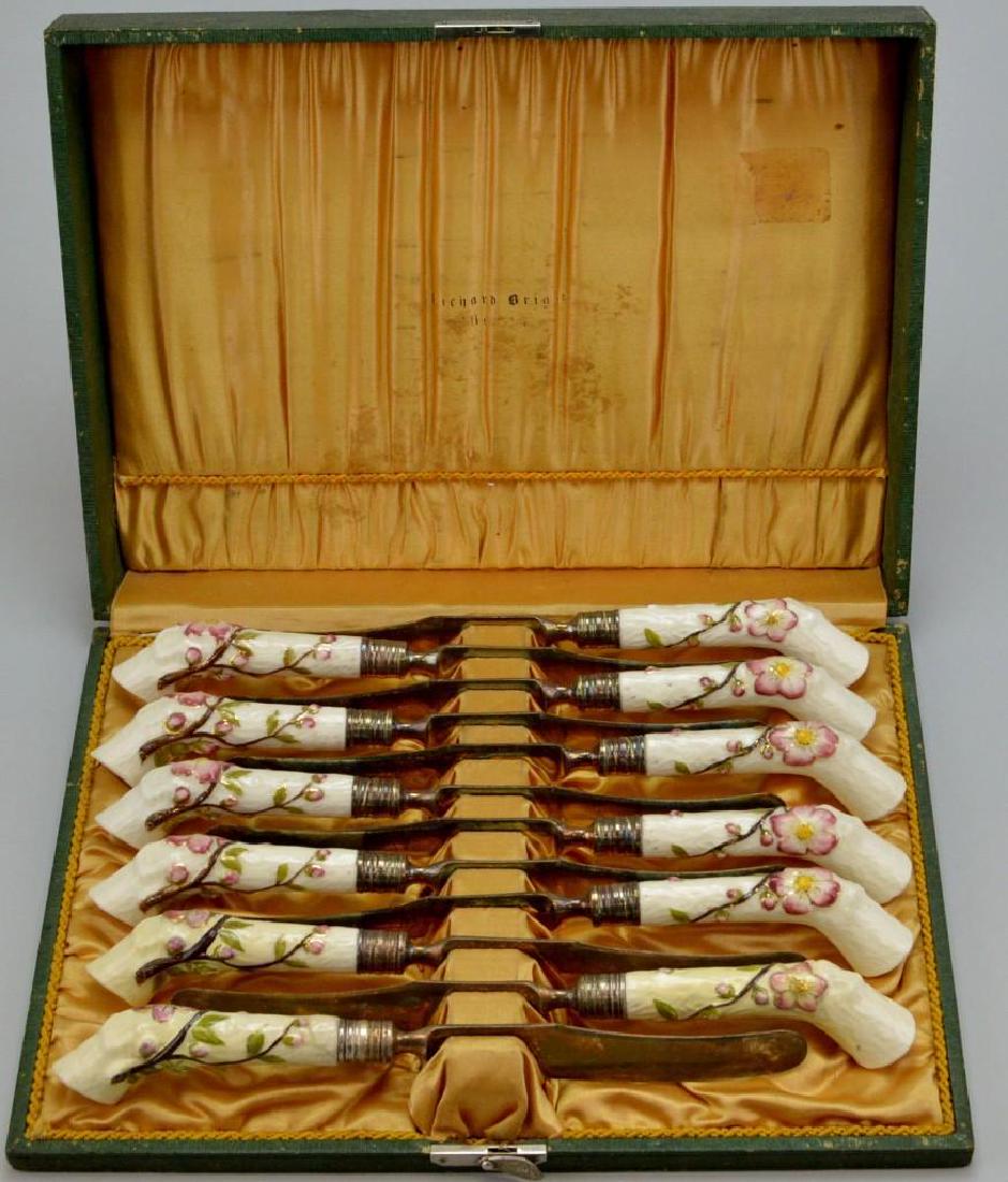 Set of Twelve Boxed Porcelain Handled Dessert Knives: Late 19th c., attributed to Royal Worcester, retailed by Richard Briggs, Boston, with crabstock handles twined with apple blossoms, silvered endcaps, in fitted case.