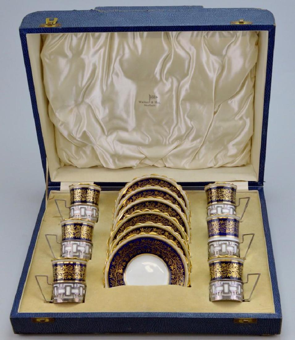 Aynsley Porcelain Sterling Silver Overlay Demitasse Set: (6) cups and saucers in fitted case. Cobalt blue and gilt decorated. Hallmarked Walker and Hall, Sheffield.
