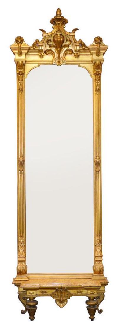19th C. Giltwood Carved Monumental Pier Mirror and Base: Ornate urn, C-scroll, and floral crest with molded and urn columns with an arrowhead foliate carved base over a marble top pier table with a carved frieze on round legs, 43”w x 16”d. 11'5"h x 44"w