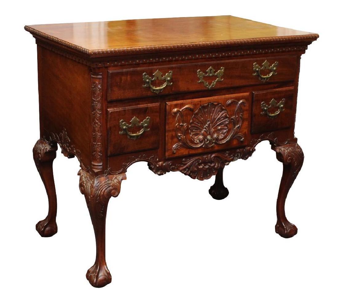 Chippendale Mahogany Lowboy: Scrolled and Roman Key molded top, floral carved columns, five drawers with a shell carved center drawer, carved acanthus frieze and knees on ball and claw feet, 20th C. 31”h x 34.5”w x 21”d