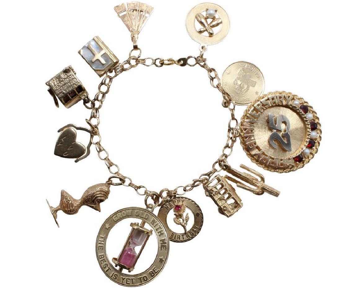 14K Yellow Gold Charm Bracelet with Charms: 7 1/2" long. 4.3mm wide triple link style with spring ring clasp. Charms soldered to bracelet include: Bowling pins with 4.0mm Pearl, Cancer zodiac sign, 25th Anniversary with Garnet and Pearls, Cac