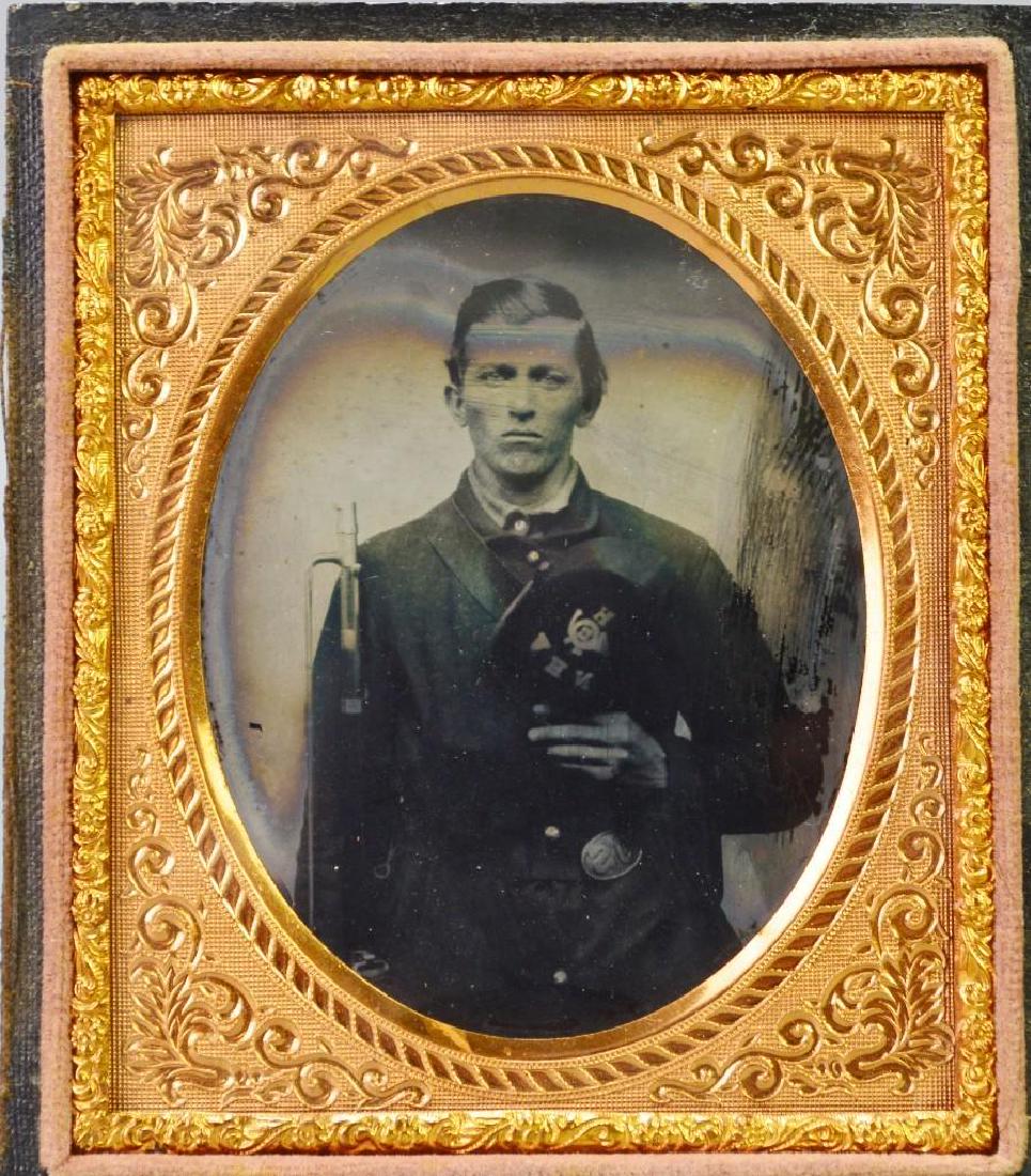 Civil War Ambrotype of Private Warren Howe-11th New: Sixth plate ruby ambrotype of Civil War soldier Private Warren Howe, Company H, 11th New Hampshire Volunteer Infantry. Image shows Howe standing knees up wearing a 4-button sack coat holding musket wi