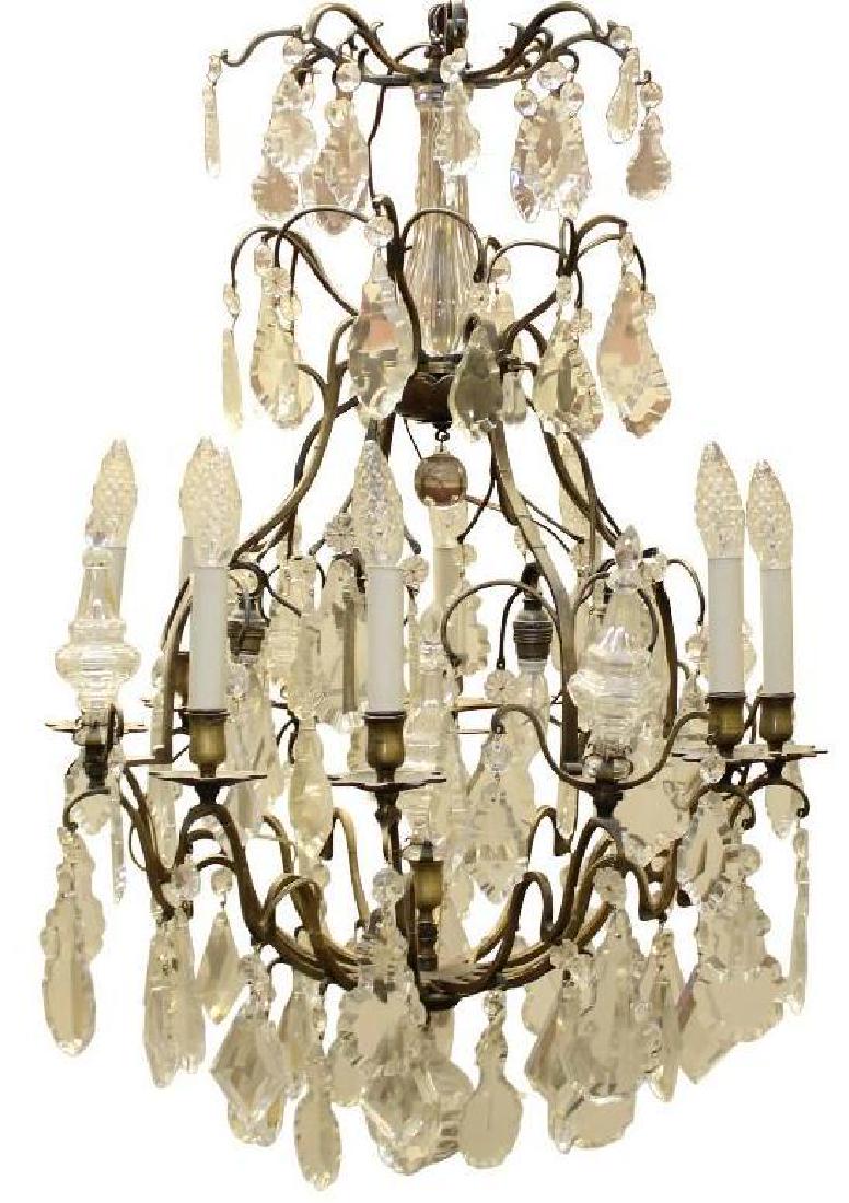French 19th Century Louis XV Style Baccarat Crystal: (8) arm chandelier with open cage, beautifully decorated with beaded rosettes and hanging cut crystals of various cuts and sizes. 33"h x 21"round