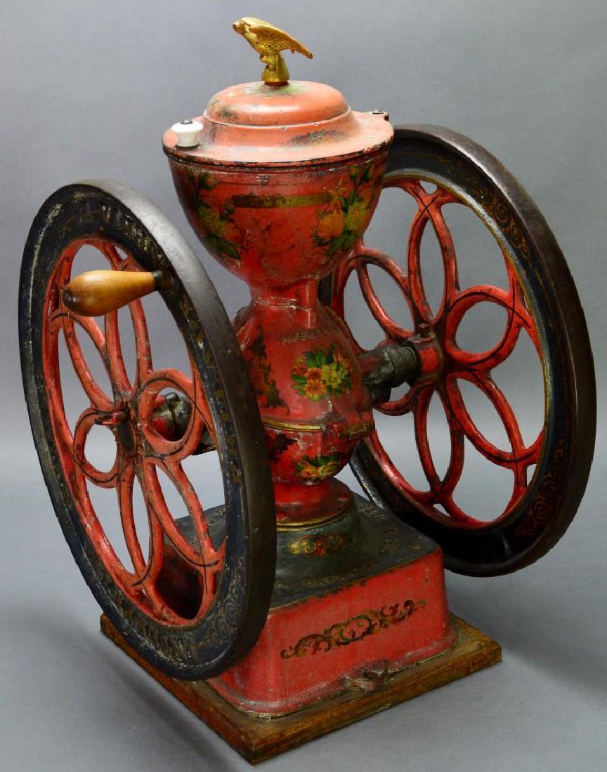 Number 7 Enterprise Coffee Mill: Enterprise Manufacturing Co., Philadelphia PA , patented Oct. 21, 1873. Painted red with toleware decoration and eagle finial, on rotating base, 17"w (includes handle) x 17.5"d x 25"h. This came out o