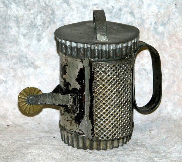 Tin Kitchen Utensil.: Includes two graters, crimper, and cookie cutters all in one cylindrical form, 4 1/2" t., 2 3/4" dia.