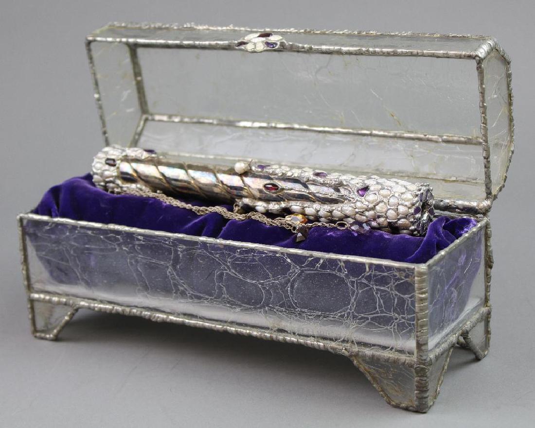 Silver Plate Stone-Encrusted Kaleidoscope: Silver plate cylinder with encrusted stones with prism end, chain with hanging jewels. In felt-lined glass box