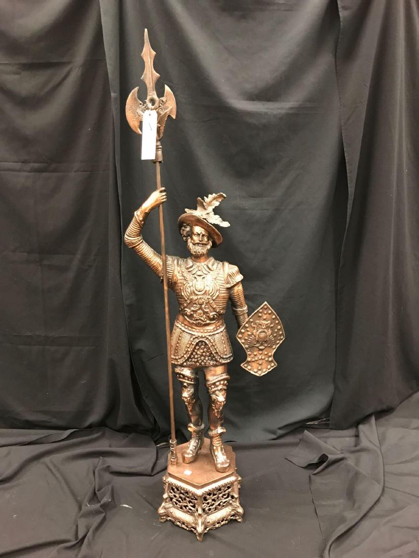 Cavalier Statue: Metal cast statue with copper finish of a cavalier with spear and shield, 23"w x 62"h.