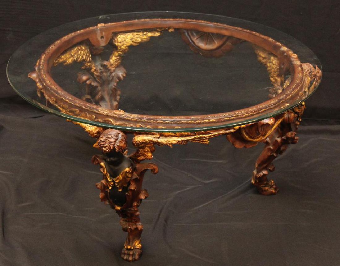 Figural Glass Top Table: Resin base with gilt and ebonized accents, figural legs with hoofed feet, 19" x 35"