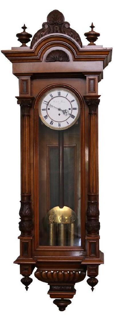 Vienna Regulator Wall Clock: Austrian, circa 1880 Walnut 50" H x 15" W x 7 1/2" D Vienna Regulator Wall clock, Altdeutsch Style, 8 day, time and Grand Sonnerie strike, three weight driven movement in a walnut case flanked by full