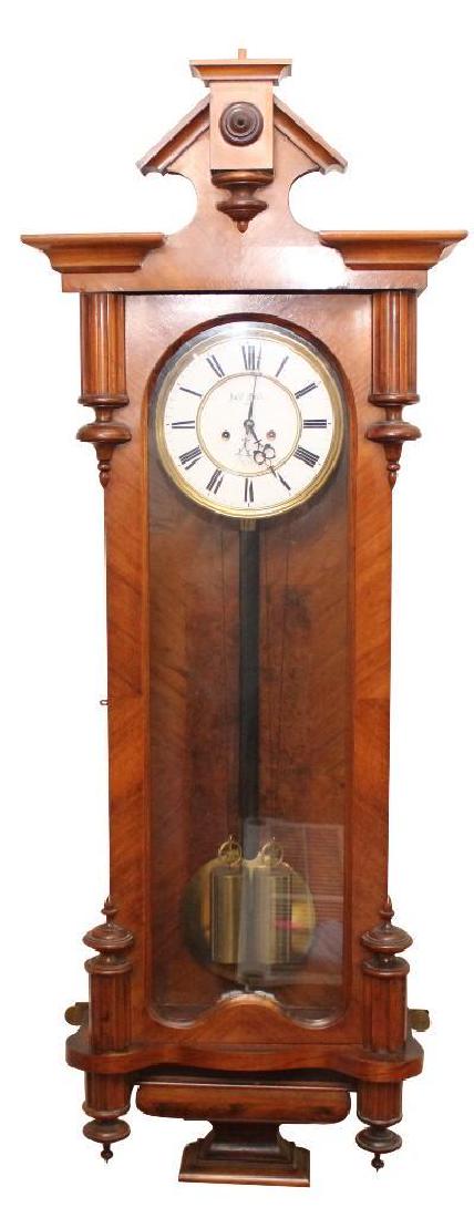 Vienna Regulator Wall Clock: 20th c. Oak 44 1/2" H x 15 3/4" W x 7" D Hand painted enamel face with Roman numerals, weight and pendulum driven. Marked "Josef Geiss Wien"