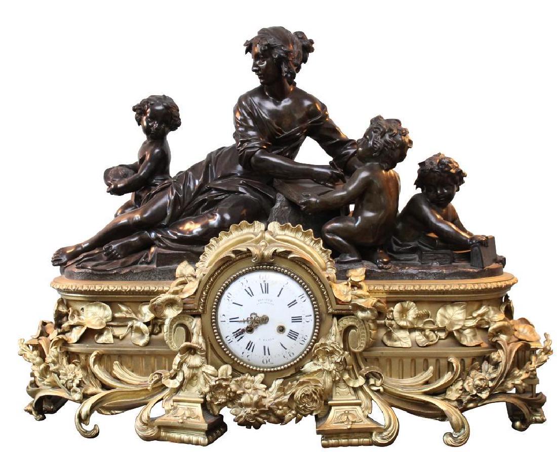French Figural Mantel Clock: French, circa 1865 Fire gilded bronze 24" H x 34" W x 14" D French fire gilded bronze mantel clock, woman surrounded with children to top, porcelain face with roman numerals, floral and leaf ormolu de